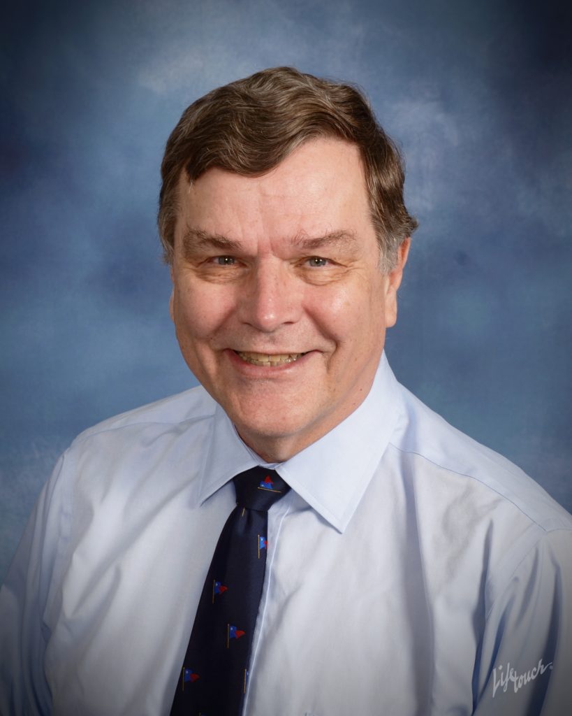 A man in a blue shirt and tie.